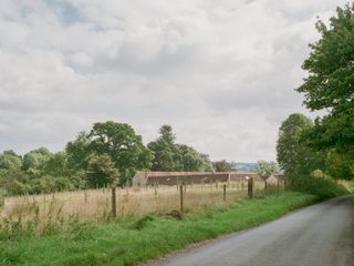 Wraxall Yard in the countryside, seen within the fields
