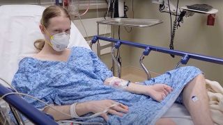 Jered Threatin in hospital wearing a hospital gown