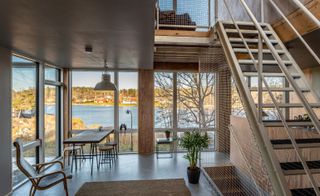 Interior shot with staircase and open views at the Container house in Sweden