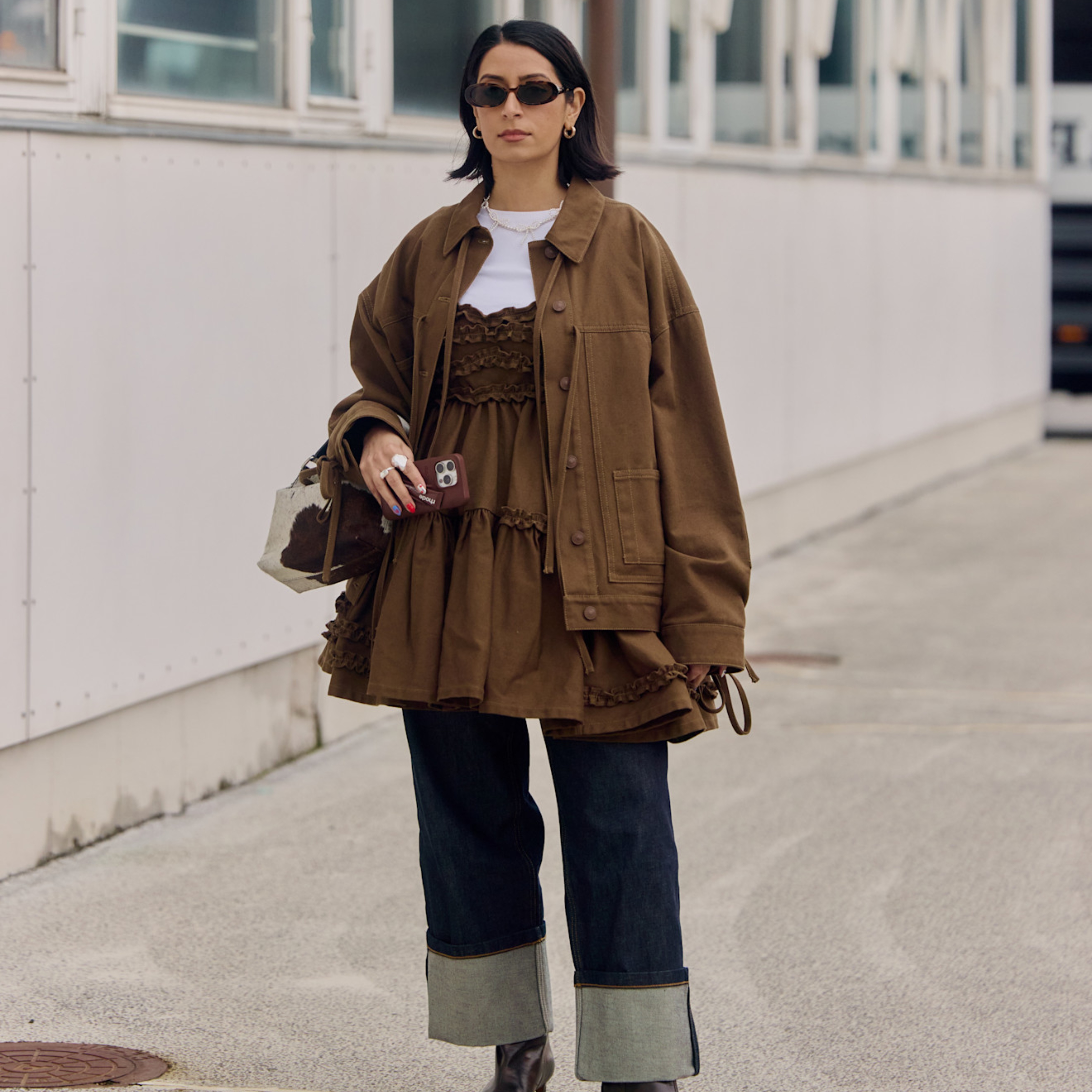 woman wearing a brown dress over jeans