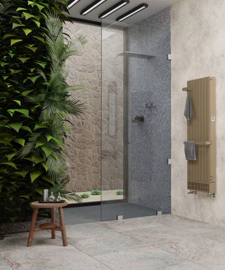 bathroom with grey tiled shower enclosure and stone coloured wall mounted radiator with towel rails