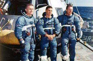Apollo 8 astronauts Frank Borman, Bill Anders and Jim Lovell take part in recovery training wearing prototype spacesuits.