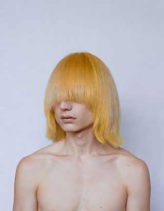 man with long yellow hair over his face
