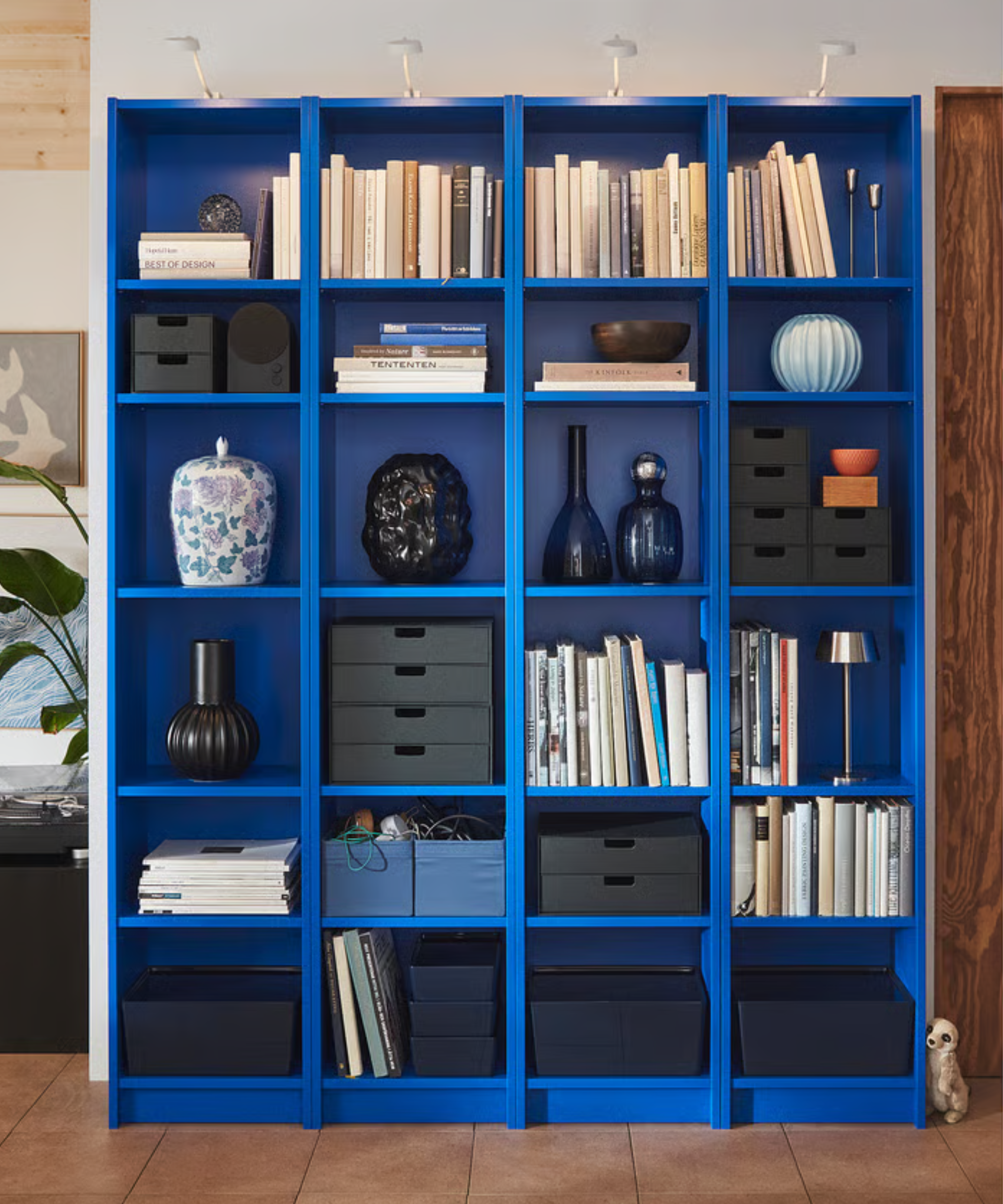 a bright blue bookcase with decor on it from IKEA