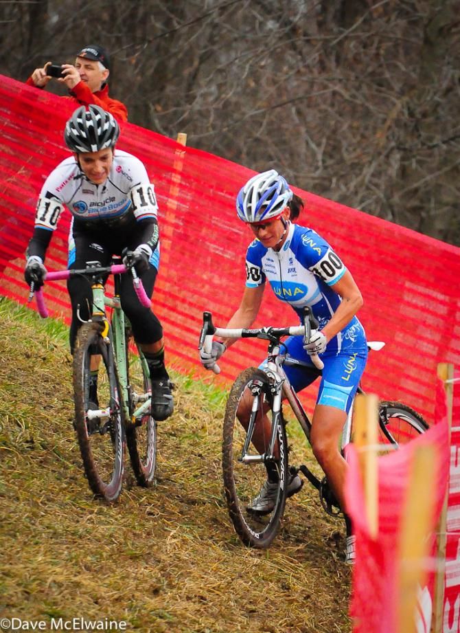 Katerina Nash (Luna Pro Team) slides out on an off-camber section of course as Elle Anderson motors away