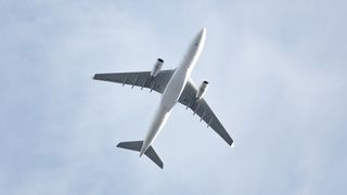 An image of the underside of an airplane as it is flying