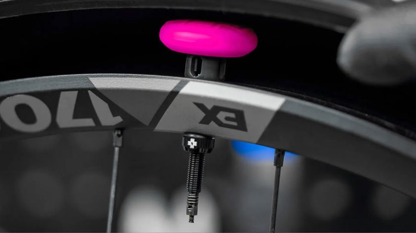 The Muc-Off Stealth AirTag holder installed inside a wheel, showing how the system hides an Apple AirTag