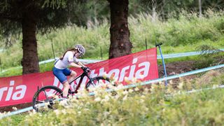 Isla Short on a steep climb at the World Championships in Glentress 2023