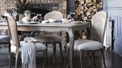 grey dining room table and chairs in French style, exposed brick fireplace and wood feature - cotswold company