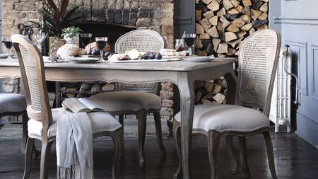 gray dining room table and chairs in French style, exposed brick fireplace and wood feature - cotswold company