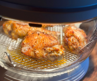 Fritaire Self-Cleaning Air Fryer cooking chicken thighs