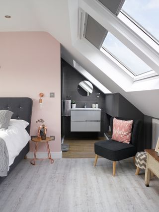 Jenny Weston loft: a grey-tiled bathroom sits to the right of the bed
