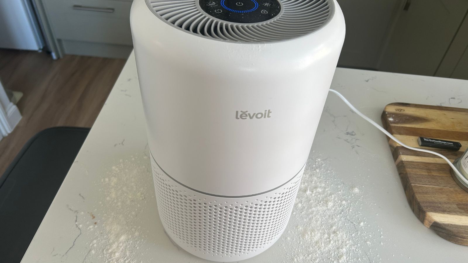 Levoit air purifier on kitchen island with flour sprinkled around it
