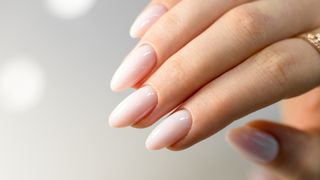 A hand with almond shaped nails