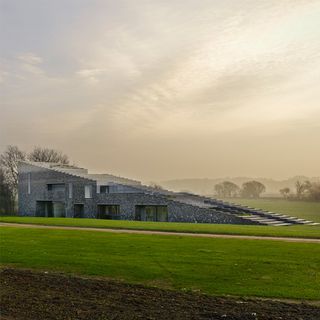 flint house with grass lawn and trees