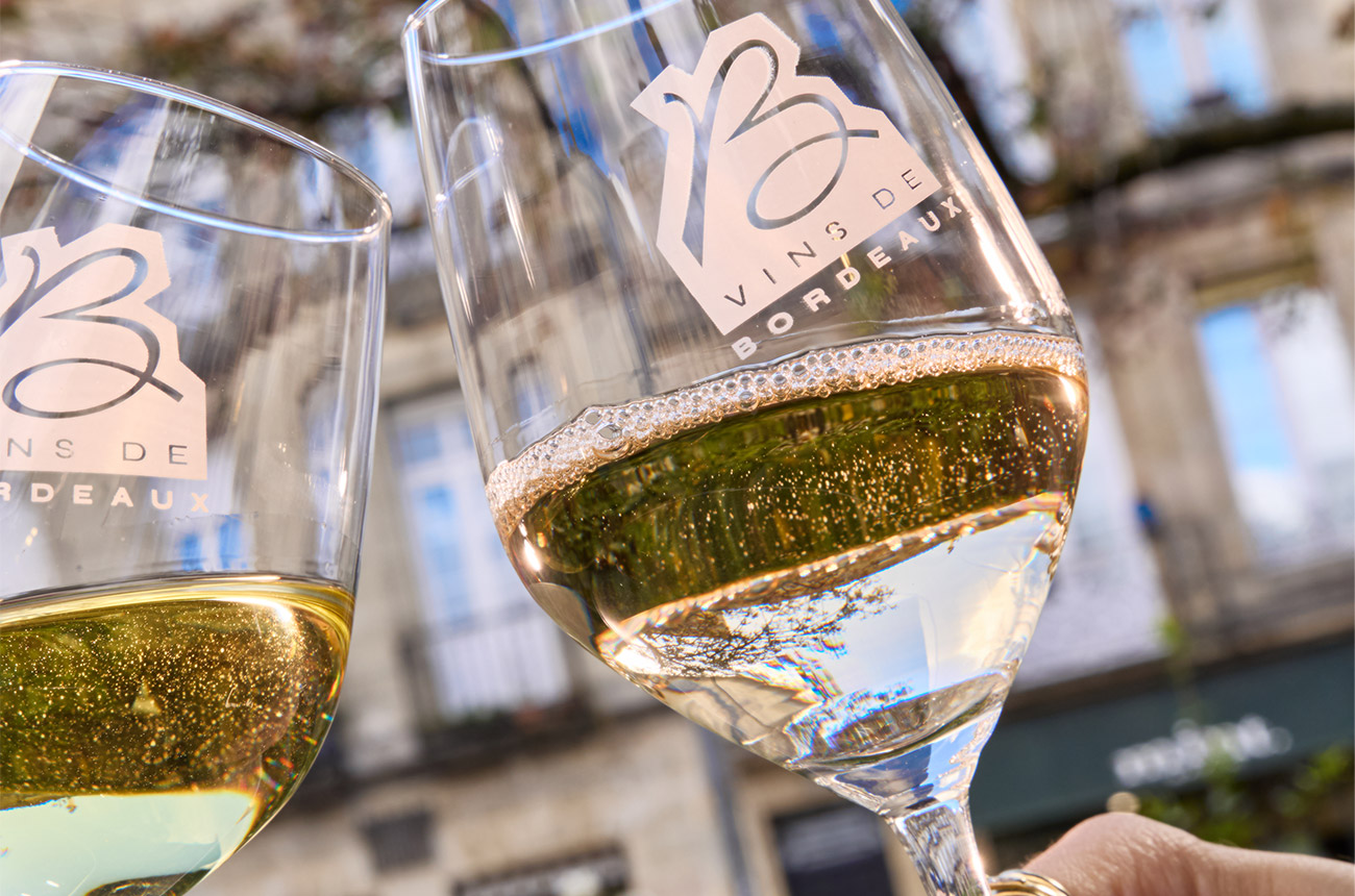 Close up of two glasses of Cr&eacute;mant de Bordeaux &ndash; with 'Vins de Bordeaux' on the glasses