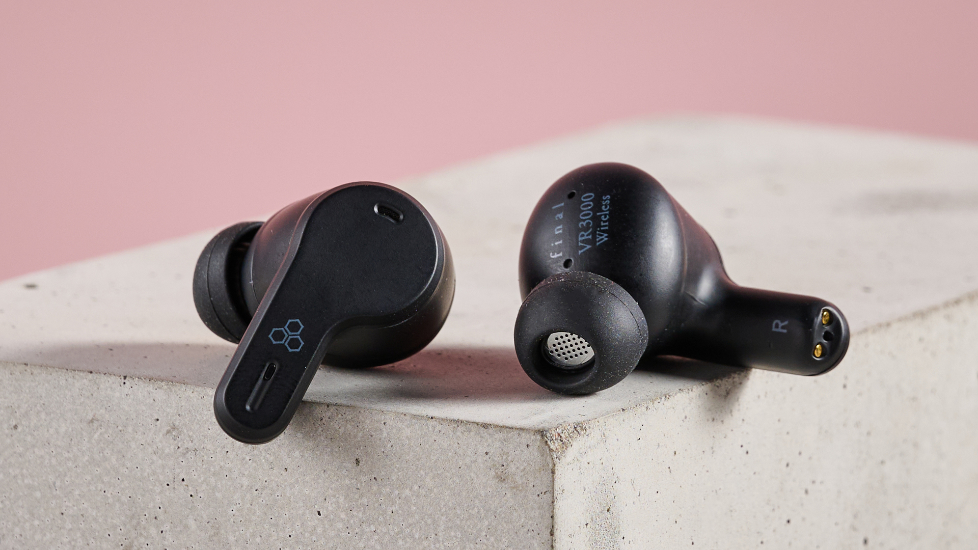 Final VR3000 Wireless earbuds on plinth with pink background