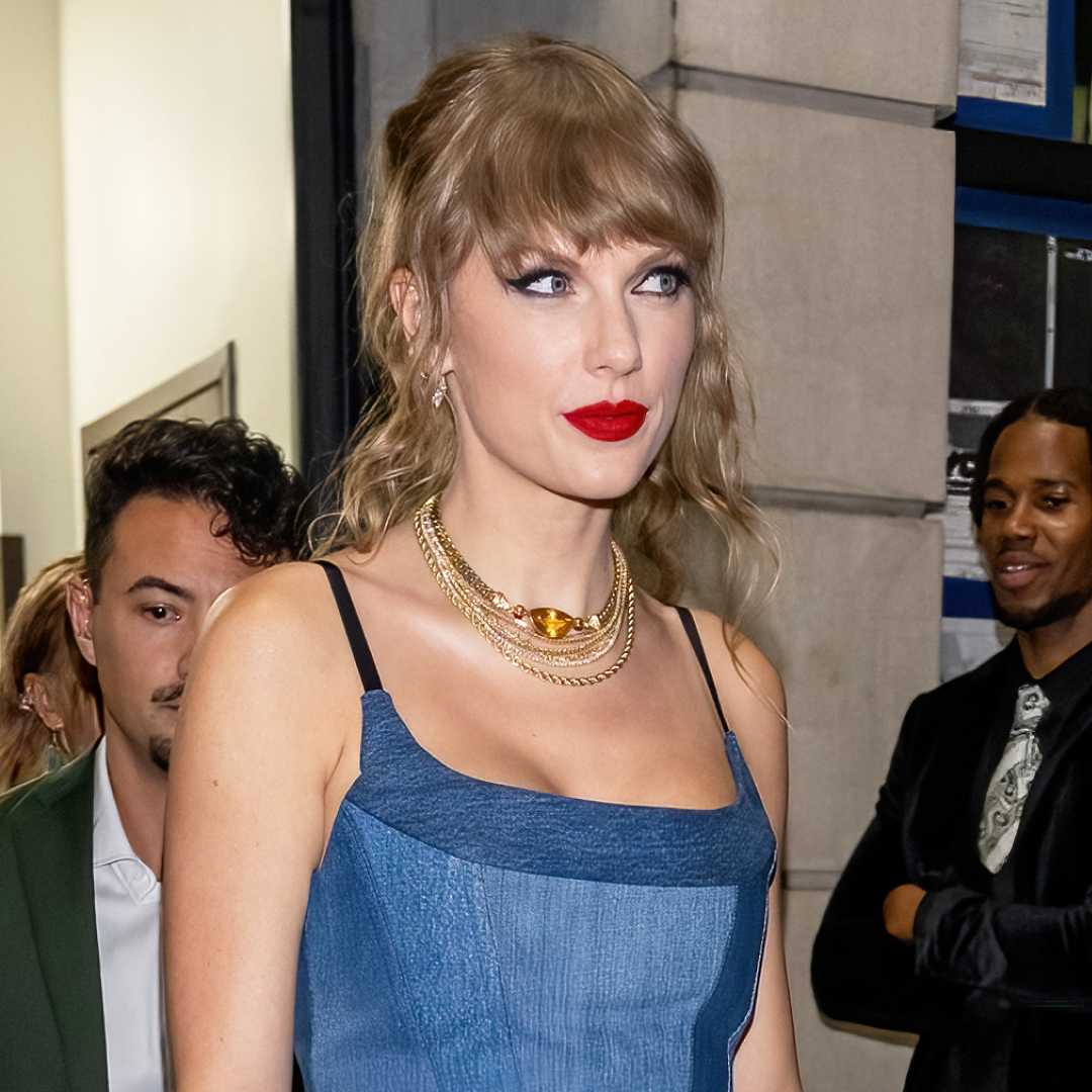 Taylor Swift delivers a surprise performance in a black denim EB Denim dress