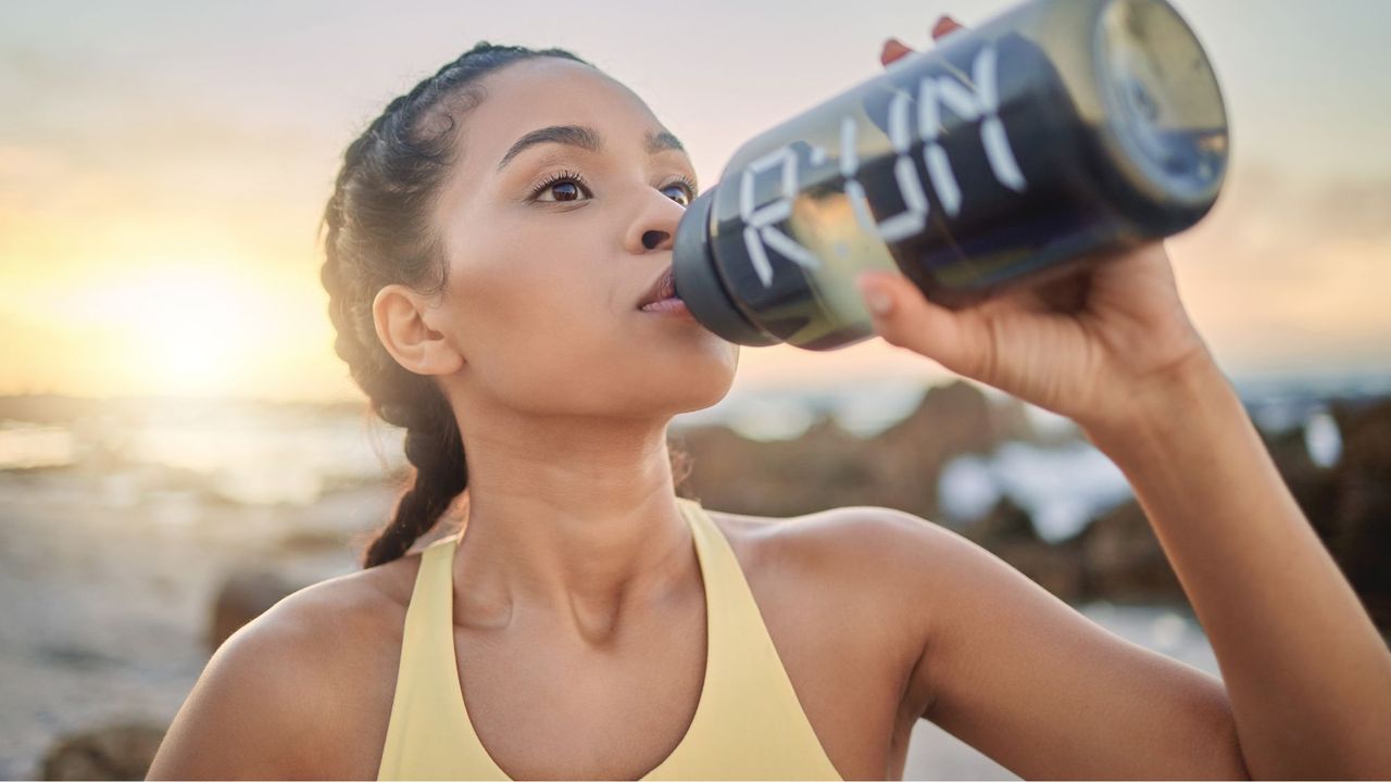 Cardio workouts at home: A woman drinking water