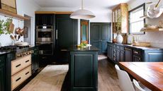 dark kitchen with wood accents and rug and island unit