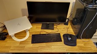 The Revive Gaming Desk standing in a small home office