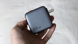 Ugreen Nexode 65W charger held in a hand