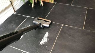 Shark WandVac cleaning flour from a kitchen floor