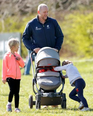 STROUD, UNITED KINGDOM - MARCH 24: (EMBARGOED FOR PUBLICATION IN UK NEWSPAPERS UNTIL 24 HOURS AFTER CREATE DATE AND TIME) Isla Phillips (L) looks on as Mia Tindall walks alongside her father Mike Tindall whilst pushing daughter Lena Tindall in her pushchair as they attend the Gatcombe Horse Trials at Gatcombe Park on March 24, 2019 in Stroud, England. (Photo by Max Mumby/Indigo/Getty Images)