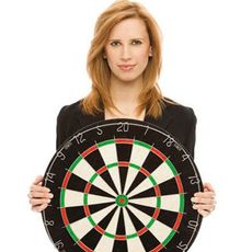 Woman holding dart board
