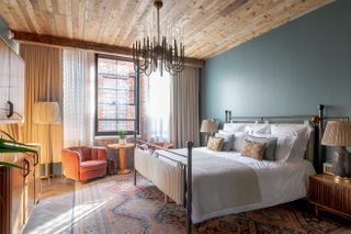 a modern bedroom with a paneled timber ceiling