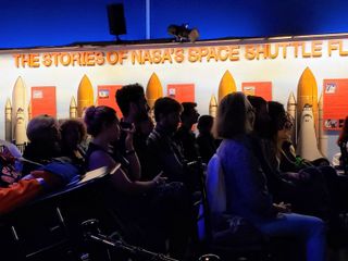 A crowd listens to a presentation by author Douglas Brinkley on June 14 at the Intrepid Sea, Air & Space Museum in New York City.