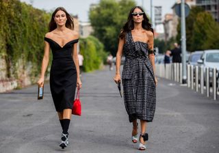 Fashion week attendees wear black dresses