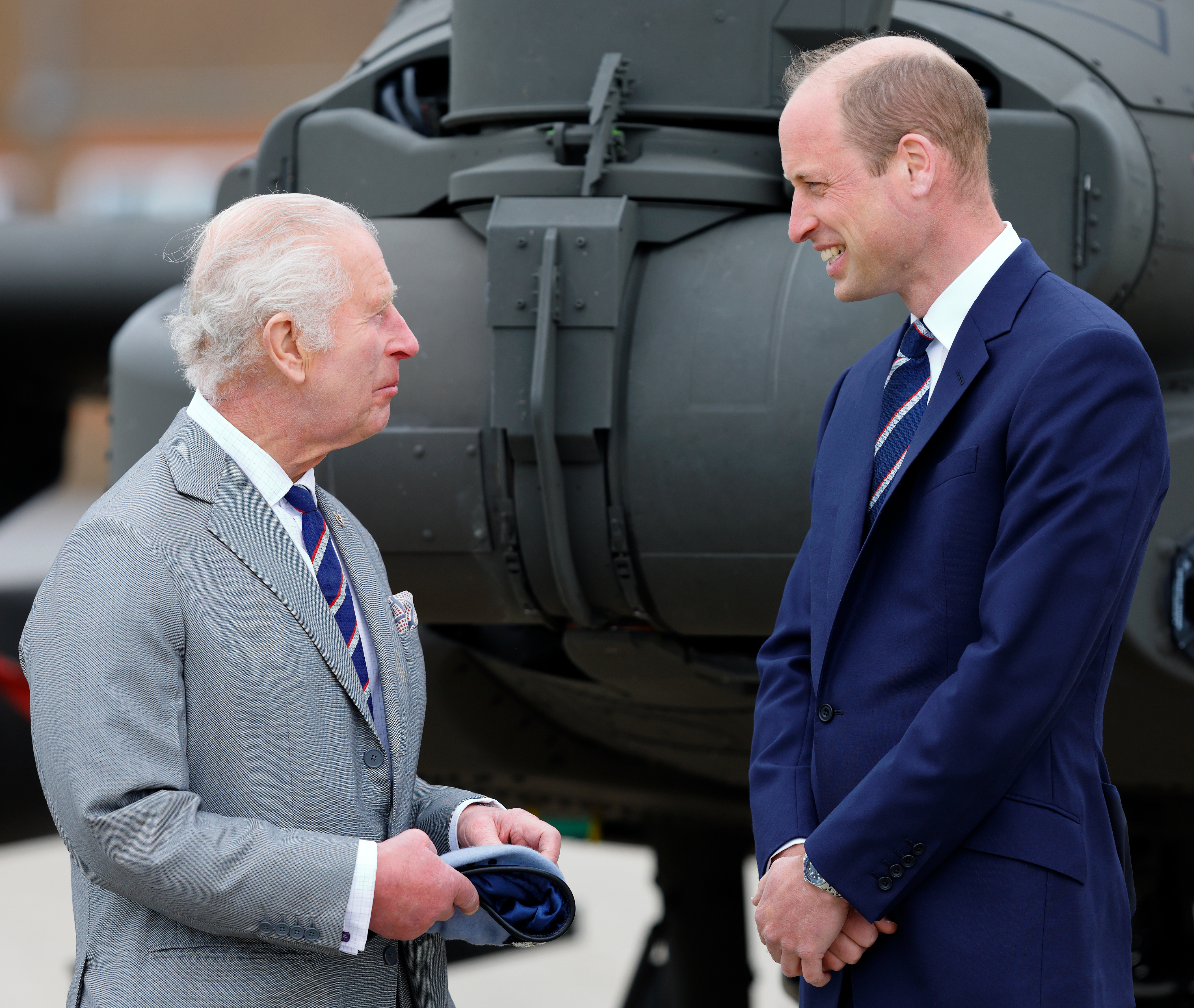 King charles and Prince William wearing striped ties and suits