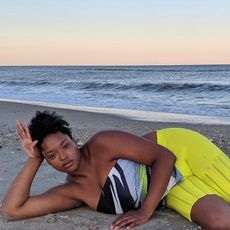 Imani Randolph laying on the beach