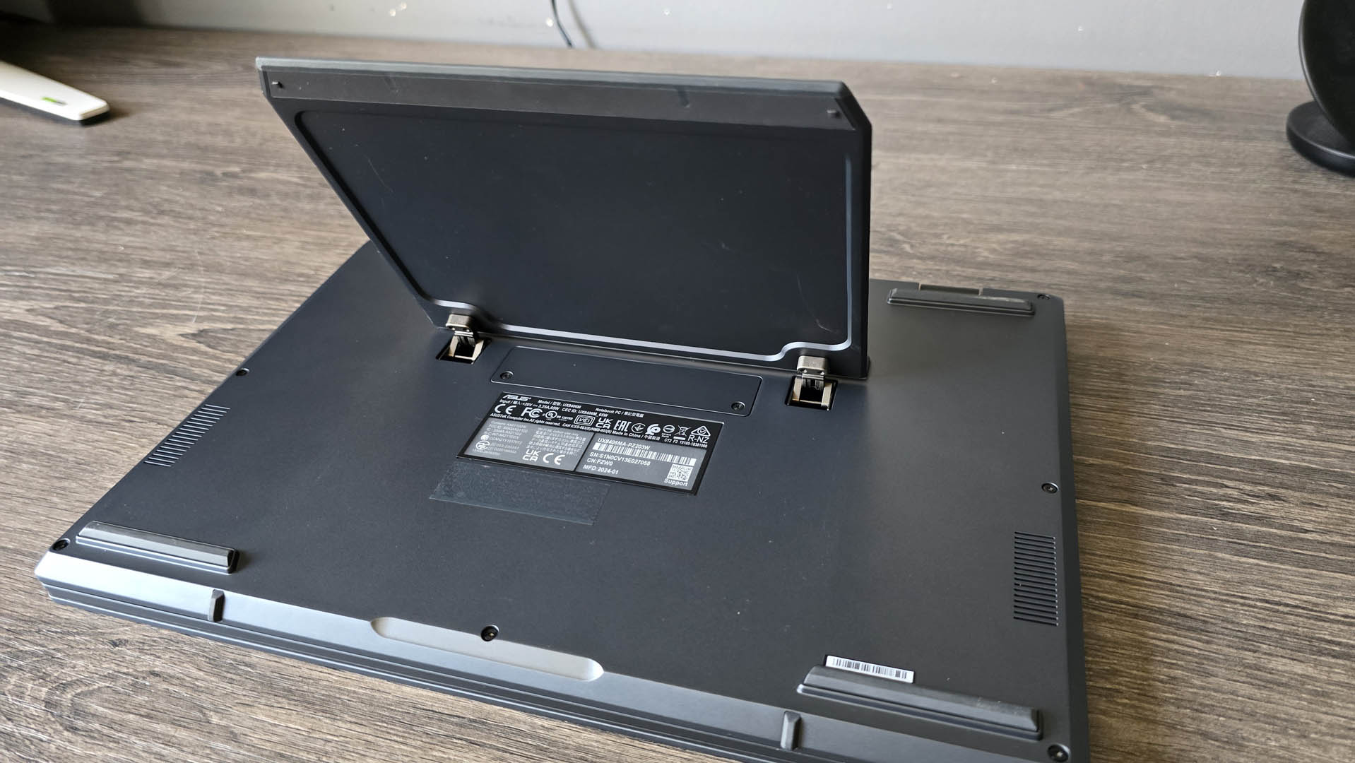 The Asus Zenbook Duo laptop photographed on a wooden desk.