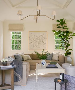 living room with neutral walls and sectional with pillows