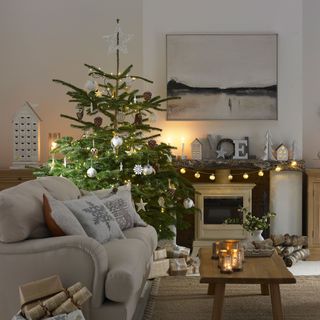 Christmas tree in corner of a room with neutral decorations