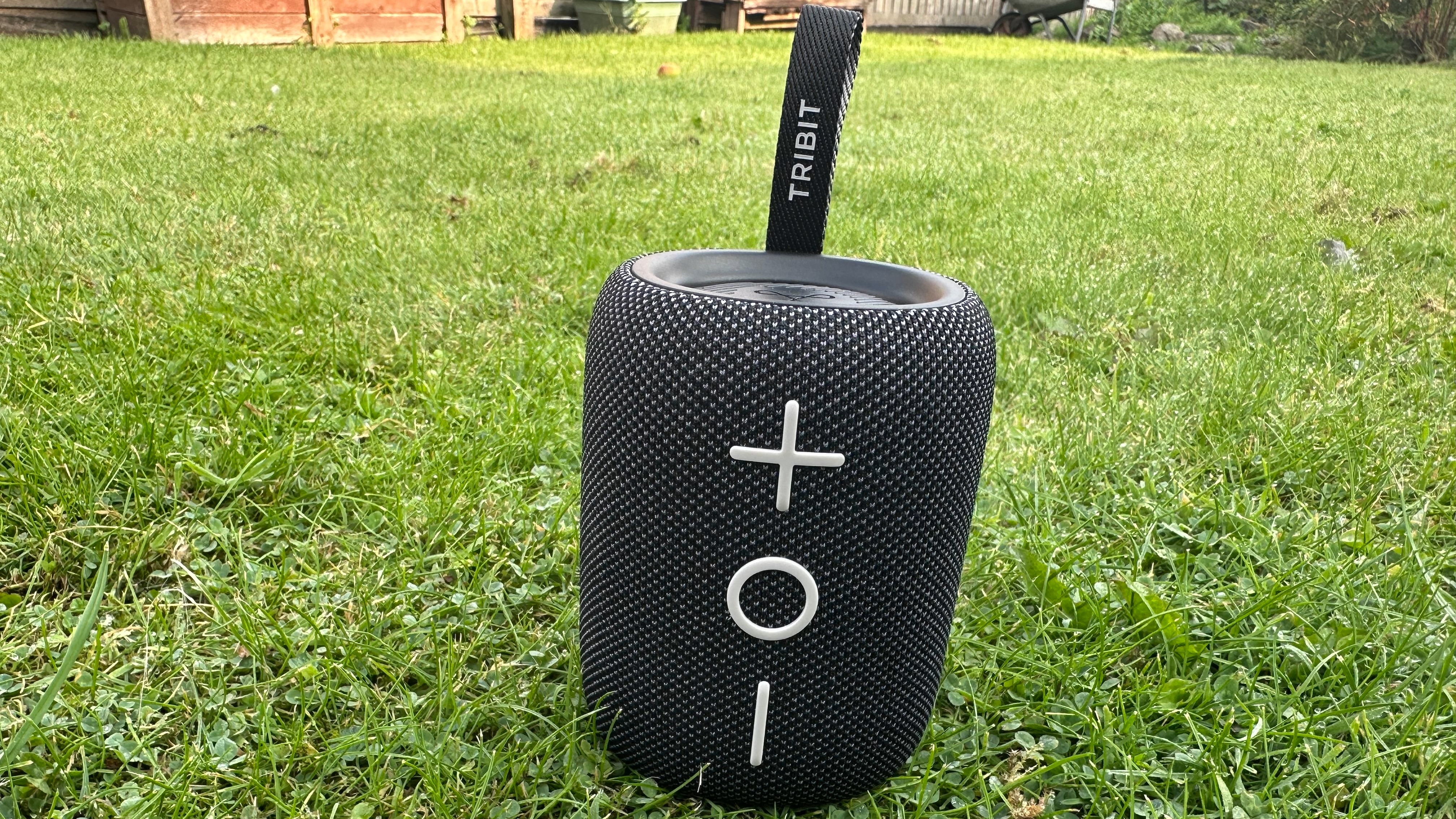 Tribit Stormbox Mini Plus Bluetooth speaker on a grassy surface