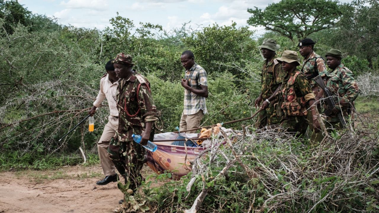 Security personnel carry a rescued young person from the forest in Shakahola