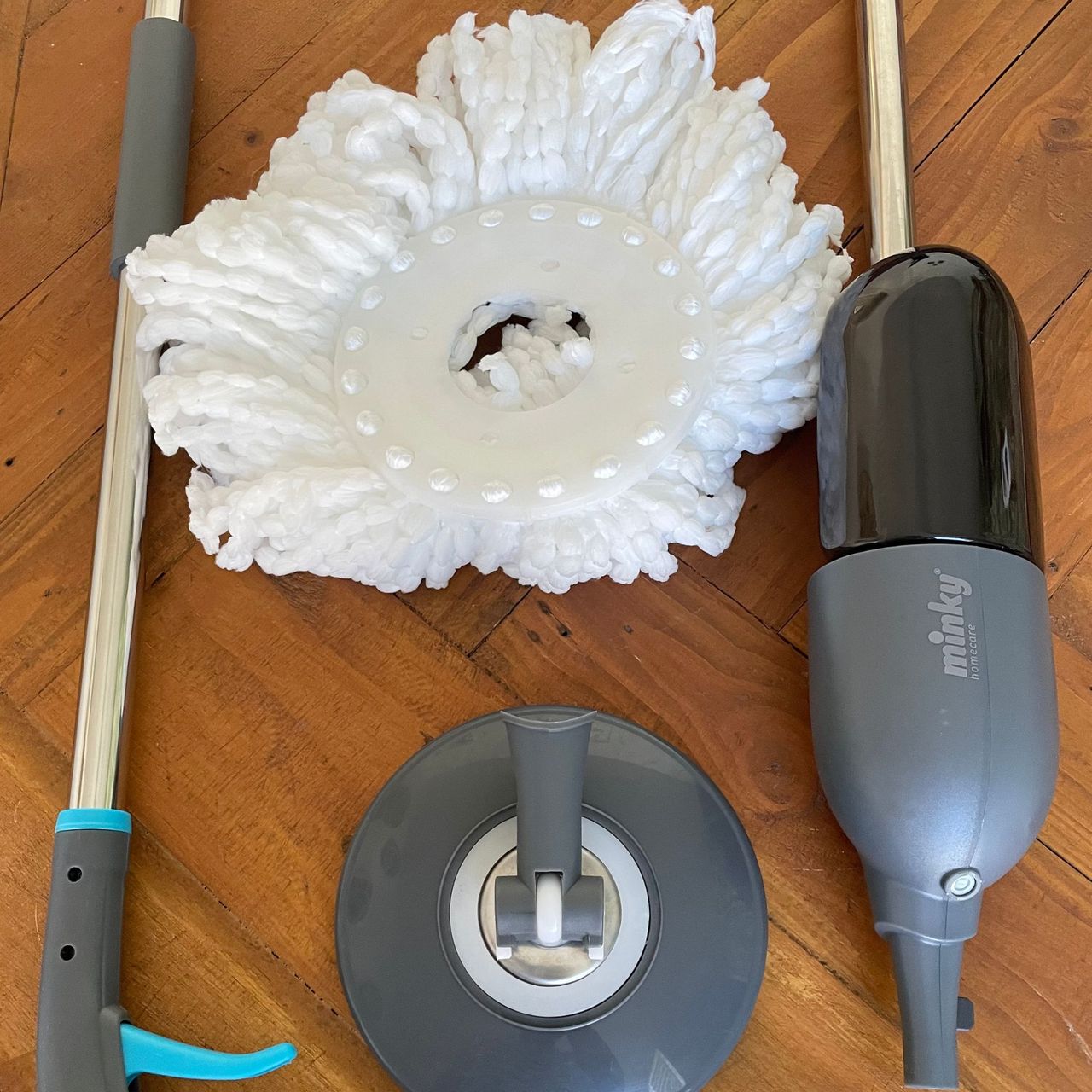 Minky Spritz &amp; Spin Spray Mop components on a wooden table