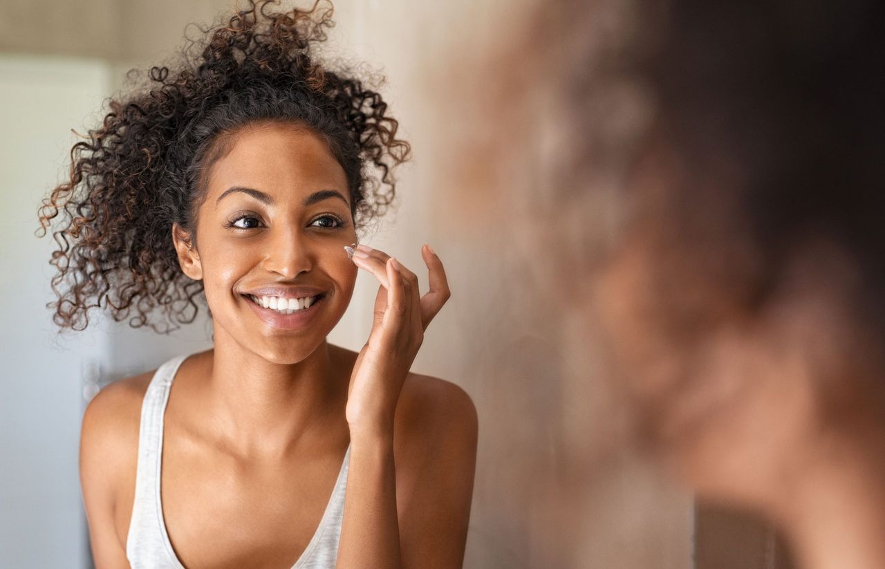 Woman putting Olay on her face