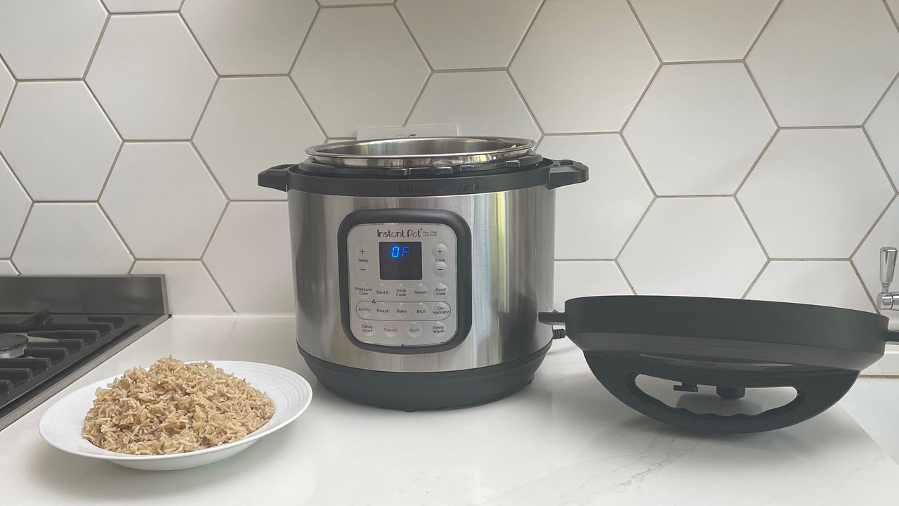Instant Pot Duo Crisp &amp; Air Fryer on a kitch countertop next to a bowl of rice