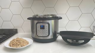 Instant Pot Duo Crisp & Air Fryer on a kitch countertop next to a bowl of rice