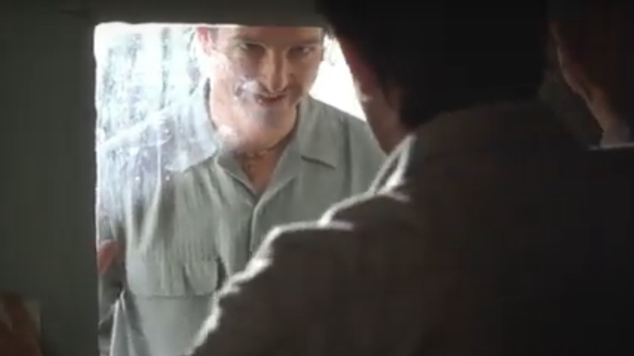 William Mapother looking creepily through a door window in In the Bedroom