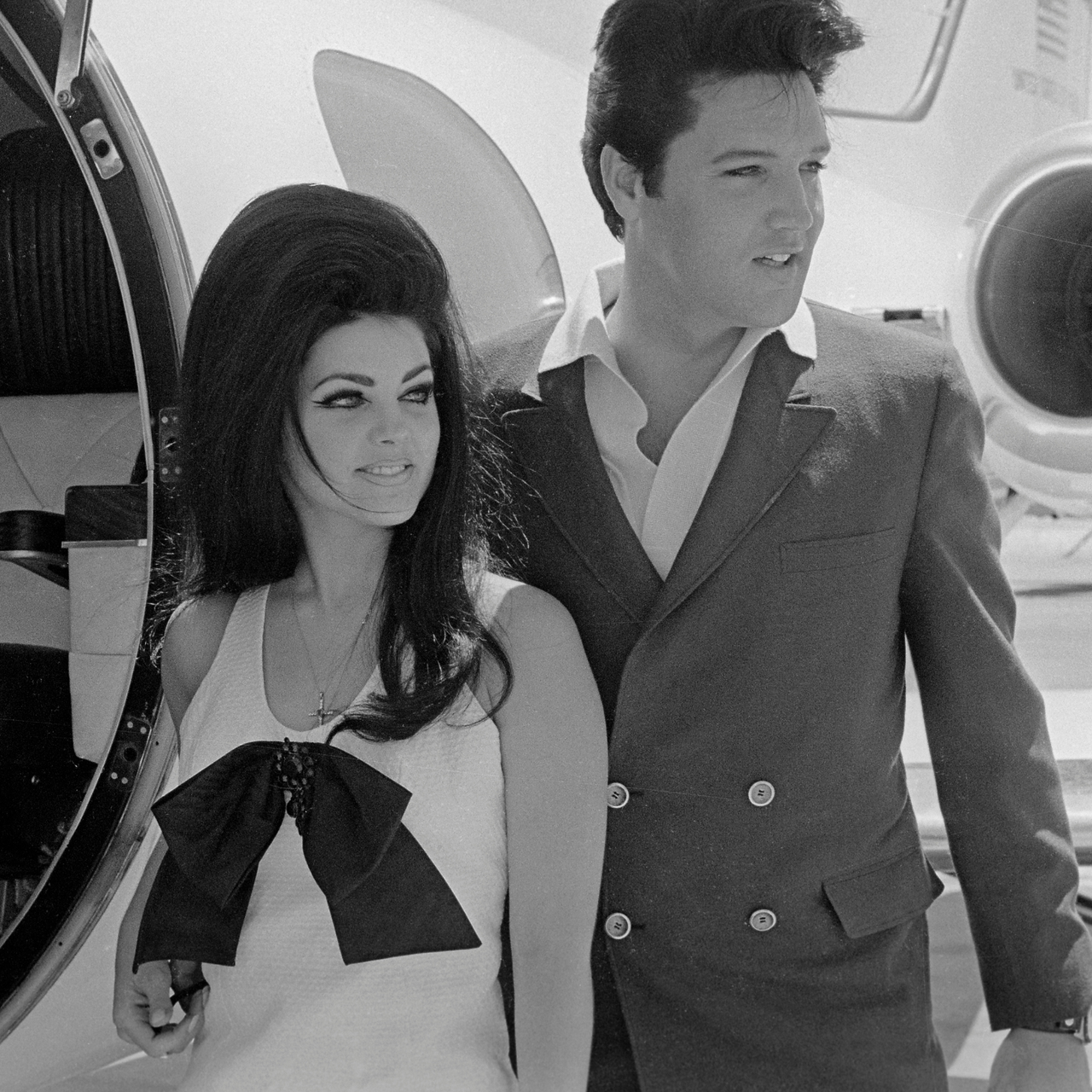 Elvis and Priscilla Presley Posing near Airplane