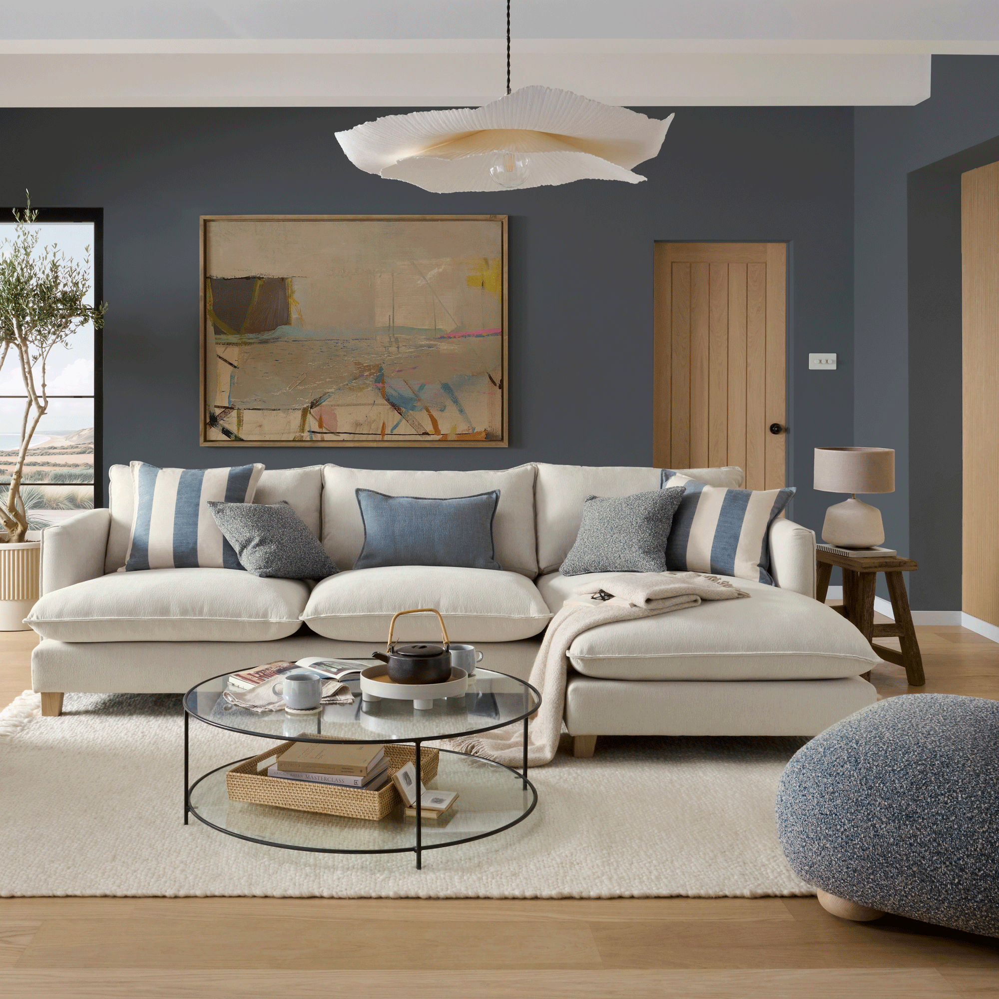 blue living room with a cream sofa and striped blue and cream cushions