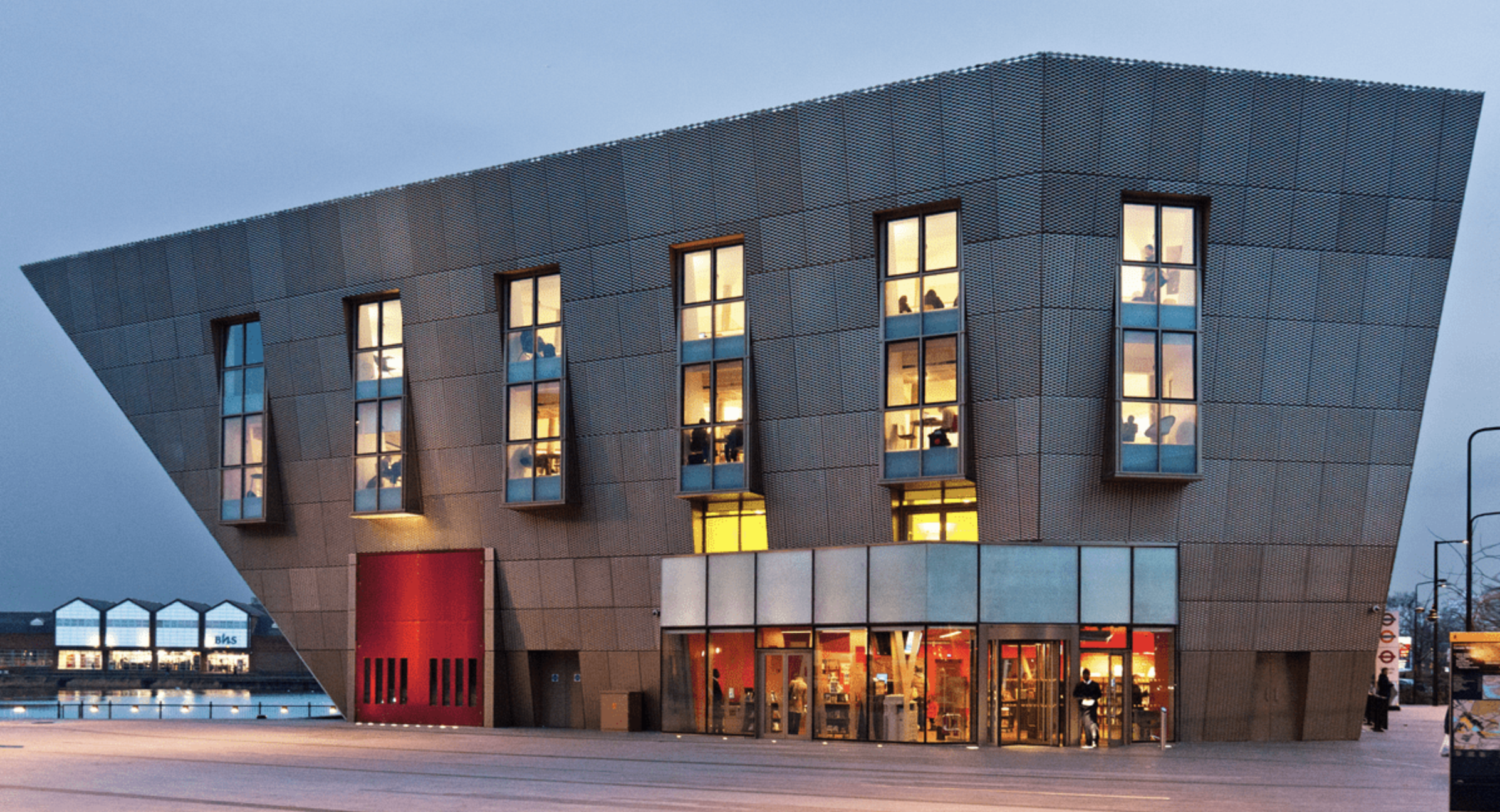 an image of the exterior of the Canda Water Library, which looks a little like something a drawing from a children's book with an elongated, asymetrical shape