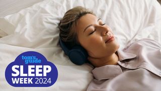 Smiling woman wearing headphones falls asleep while listening to bedtime stories for adults