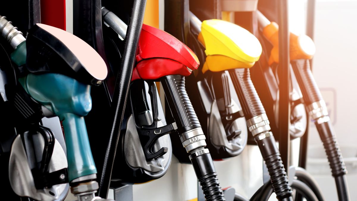 four red and yellow gas pumps