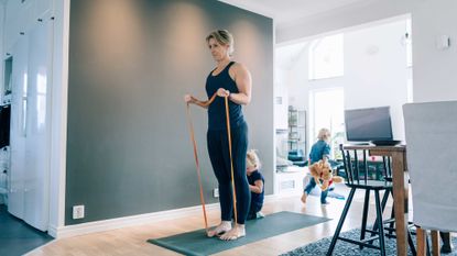 Woman training with resistance bands